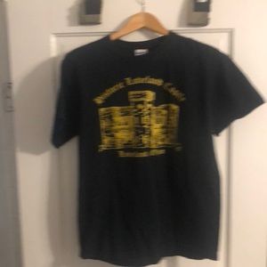 Black T-shirt on front says district Loblin castle Loveland Ohio in Gold